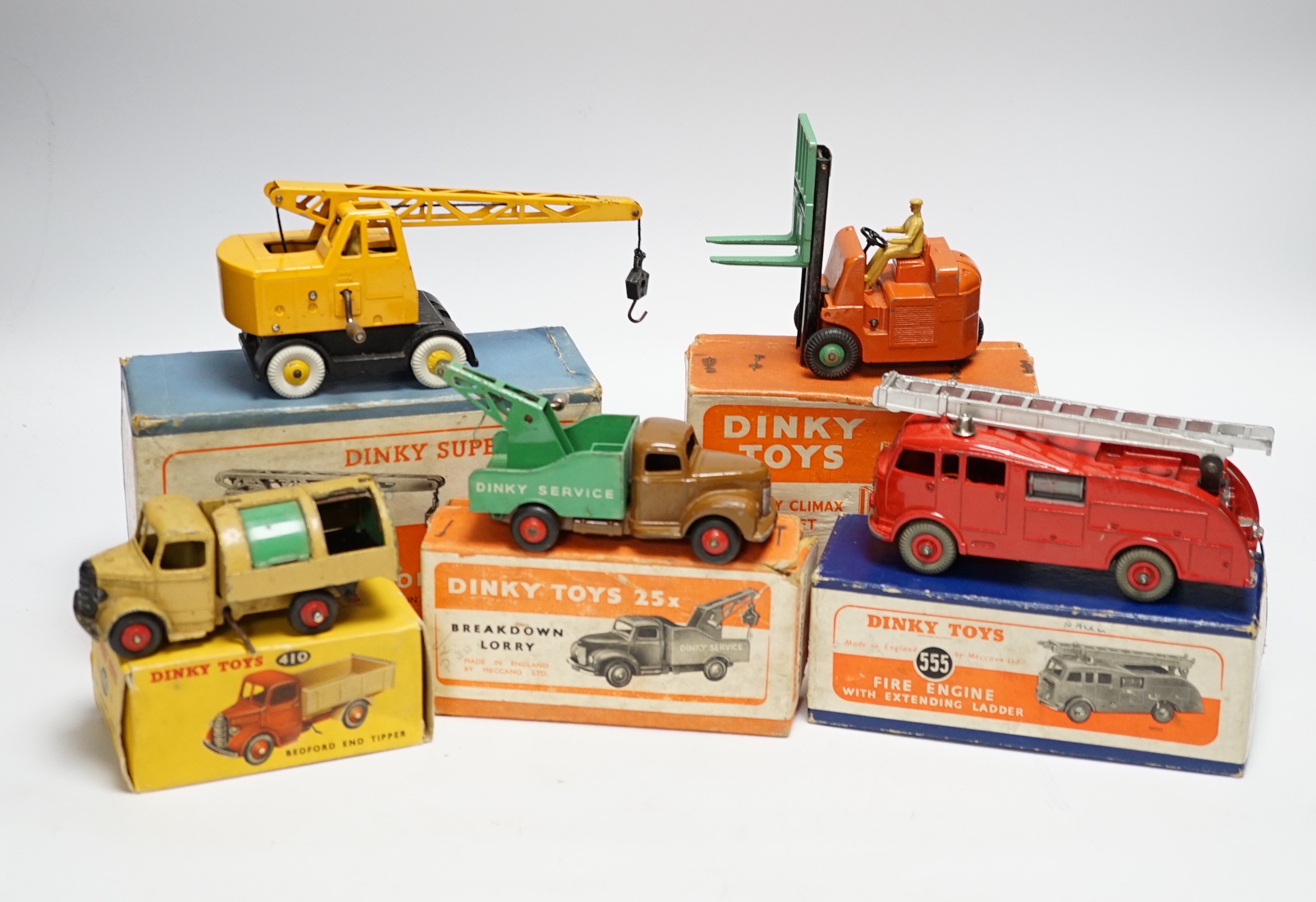 Five boxed dinky toys including (25x) breakdown lorry, (410) Bedford End Tipper, (555) Fire Engine, (571) Coles Mobile Crane, and (14c) Coventry Climax Fork Lift Truck